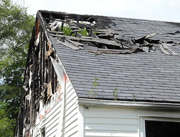 A Storm-damaged house stands in need of restoration, highlighting the impact of recent storms on its structure and integrity.