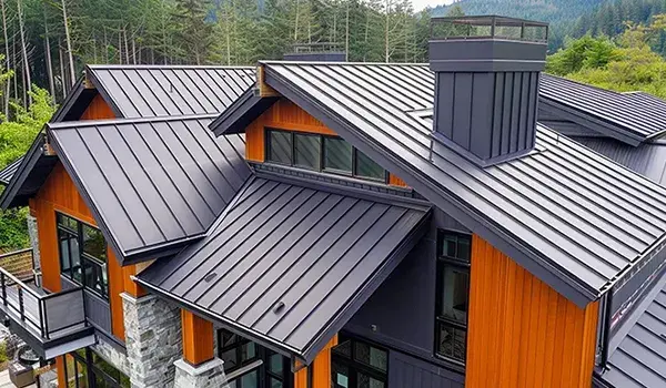 A house featuring a durable metal roof and an expansive deck, showcasing modern architectural design and outdoor living space.
